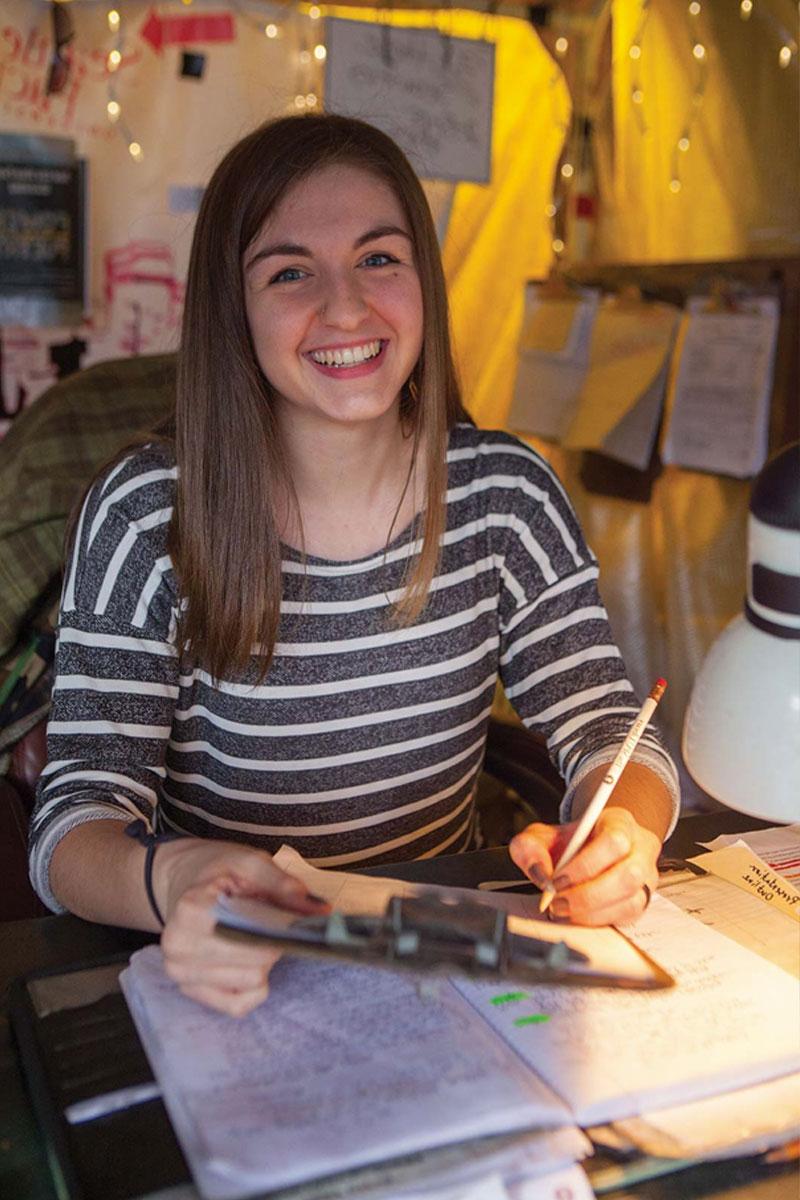 Sociology student working the desk at Tent City
