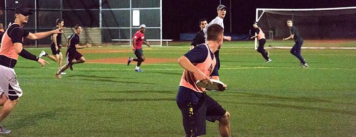 SPU students playing intramural ultimate frisbee at night